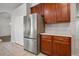Kitchen showcasing stainless steel appliances and rich wood cabinets with a side-by-side refrigerator at 1253 Bramley Ln, Deland, FL 32720