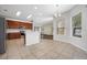 Bright kitchen with tile flooring, stainless steel appliances, wood cabinets, and an island at 1253 Bramley Ln, Deland, FL 32720