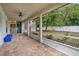Screened-in lanai with brick flooring, ceiling fan, and view of fenced backyard at 1253 Bramley Ln, Deland, FL 32720