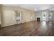 Open living room with laminate wood floors, fireplace, and natural light at 1253 Bramley Ln, Deland, FL 32720