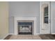 Living room showing the fireplace with white mantel and gray accent wall at 1253 Bramley Ln, Deland, FL 32720
