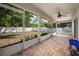 Screened-in patio boasts brick pavers and a ceiling fan for outdoor relaxation and enjoyment at 1253 Bramley Ln, Deland, FL 32720
