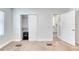 A bedroom with neutral carpeting and walls, closet, and access to the hall and bathroom at 130 Harrison Rd, Daytona Beach, FL 32118