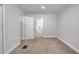 This modern bedroom features neutral carpeting and paint, plus easy access to the hallway and bathroom at 130 Harrison Rd, Daytona Beach, FL 32118