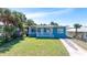 Charming blue one-story home with white trim and a small front porch, situated on a well-maintained lawn at 130 Harrison Rd, Daytona Beach, FL 32118