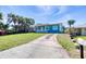 Inviting home with a well-kept lawn, a classic white-railed porch, and a convenient driveway leading to the residence at 130 Harrison Rd, Daytona Beach, FL 32118