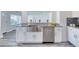 This kitchen offers a stainless sink and appliances with gray wood floors and granite counters at 130 Harrison Rd, Daytona Beach, FL 32118