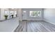 Inviting living area with gray wood-style flooring and neutral walls, offering versatility and comfort at 130 Harrison Rd, Daytona Beach, FL 32118