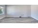 Spacious living room has neutral paint and gray wood flooring, offering a blank canvas for personalization at 130 Harrison Rd, Daytona Beach, FL 32118