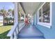 Relax on the quaint front porch, featuring a cozy seating area and a charming view of the surrounding landscape at 130 Harrison Rd, Daytona Beach, FL 32118