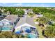 Aerial view showcasing the property with its screened-in pool and surrounding neighborhood at 13944 Huntwick Dr, Orlando, FL 32837