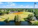 Aerial view showcasing the baseball field surrounded by lush landscaping with a lake nearby, a beautiful place to spend time at 13944 Huntwick Dr, Orlando, FL 32837