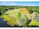 A baseball field with a lush green field, and surrounding trees. A great place to spend time with friends and Gathering at 13944 Huntwick Dr, Orlando, FL 32837