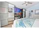 Open bedroom area with mirrored closets, a ceiling fan, and an office area at 13944 Huntwick Dr, Orlando, FL 32837