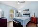 A cozy bedroom boasts a ceiling fan, a window view, and a comfortable double bed at 13944 Huntwick Dr, Orlando, FL 32837