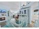 Bright dining area features a glass table, fireplace, and views to the living area for open concept living at 13944 Huntwick Dr, Orlando, FL 32837
