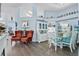 Open-concept living and dining area featuring elegant furniture, decor, and hardwood floors at 13944 Huntwick Dr, Orlando, FL 32837