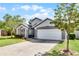 Charming single-Gathering home featuring a well-maintained lawn and brick-paved driveway at 13944 Huntwick Dr, Orlando, FL 32837