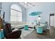 Inviting living room featuring hardwood floors, a large window, and comfortable seating, ideal for relaxing and unwinding at 13944 Huntwick Dr, Orlando, FL 32837