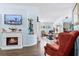 Cozy living room featuring a fireplace, hardwood floors, and comfortable seating, perfect for relaxing and entertaining at 13944 Huntwick Dr, Orlando, FL 32837