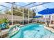 Inviting screened-in pool area with lounge chairs and a soothing water feature for relaxation at 13944 Huntwick Dr, Orlando, FL 32837