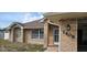 Inviting brick home with a secure front entrance, lush lawn and a charming address number at 1408 E Normandy Blvd, Deltona, FL 32725