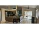 Open kitchen with a breakfast bar, stainless steel appliances, and sliding glass doors to a patio at 1408 E Normandy Blvd, Deltona, FL 32725