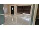 Bright, open living room with neutral walls, sleek tile floors, and a large window at 1408 E Normandy Blvd, Deltona, FL 32725