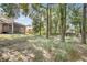 Expansive backyard with mature trees, a partial fence, and an enclosed patio at 1439 Bent Oaks Blvd, Deland, FL 32724