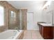 Bright primary bathroom features soaking tub, tiled shower, wood cabinets and granite countertops at 1439 Bent Oaks Blvd, Deland, FL 32724