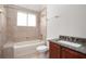 Well-lit bathroom with a tub, shower, granite-topped vanity, and convenient toilet at 1439 Bent Oaks Blvd, Deland, FL 32724