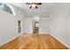 Large primary bedroom with wood floors, high ceilings, and an ensuite bathroom at 1439 Bent Oaks Blvd, Deland, FL 32724
