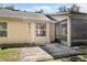 Exterior shot of a home featuring a screened patio with brick pavers and a beige exterior at 1439 Bent Oaks Blvd, Deland, FL 32724