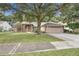 Beautiful one-story residence featuring a lush lawn, a mature shade tree, and a two car garage at 1439 Bent Oaks Blvd, Deland, FL 32724
