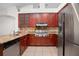 Well-equipped kitchen features wood cabinetry, granite countertops, stainless steel appliances and tile flooring at 1439 Bent Oaks Blvd, Deland, FL 32724