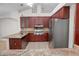Well-equipped kitchen featuring stainless steel appliances, granite countertops, and dark wood cabinetry at 1439 Bent Oaks Blvd, Deland, FL 32724