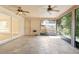 Enclosed patio with two ceiling fans, tile flooring, and screened windows, ideal for outdoor dining at 1439 Bent Oaks Blvd, Deland, FL 32724