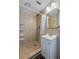 Tiled bathroom with shower, shelving, modern fixtures, and vanity at 150 Nautical Dr, South Daytona, FL 32119