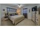 Comfortable bedroom with neutral decor, a ceiling fan, and ample natural light at 150 Nautical Dr, South Daytona, FL 32119