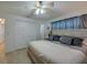 Spacious bedroom featuring a ceiling fan, closet and neutral color scheme at 150 Nautical Dr, South Daytona, FL 32119