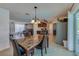 Well-lit dining area adjacent to living room and kitchen, featuring large windows and modern chandelier at 150 Nautical Dr, South Daytona, FL 32119