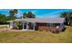 Lovely single-story home boasting mature landscaping and a brick facade under a sunny sky at 150 Nautical Dr, South Daytona, FL 32119