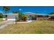Charming single-story brick home featuring a well-manicured lawn and attached garage at 150 Nautical Dr, South Daytona, FL 32119