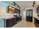 Well-lit kitchen with stainless steel appliances, dark cabinetry, and a white tile backsplash at 150 Nautical Dr, South Daytona, FL 32119