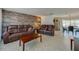 Bright living room featuring comfortable leather seating, a wood accent wall and open access to dining area at 150 Nautical Dr, South Daytona, FL 32119