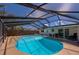 Enclosed in-ground pool with screened enclosure, ladder and chairs, offering a private swimming area at 150 Nautical Dr, South Daytona, FL 32119