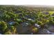 Expansive aerial view showcasing a neighborhood with mature trees, various houses, and the surrounding lush landscape at 1560 S Pearl St, Deland, FL 32720