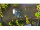 Aerial view of single story home with lush surrounding landscape and driveway at 1560 S Pearl St, Deland, FL 32720
