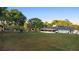 Large backyard view of the home with an enclosed patio and mature trees at 1560 S Pearl St, Deland, FL 32720
