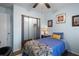 Bedroom with blue walls and bed, featuring closet with screen sliding doors at 1560 S Pearl St, Deland, FL 32720